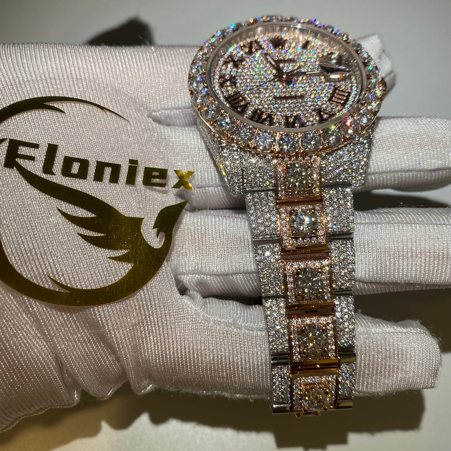 ROLEX DATEJUST ICED OUT WITH ROSE GOLD ROMAN DIAL – LARGE STONES BEZEL TWO-TONE