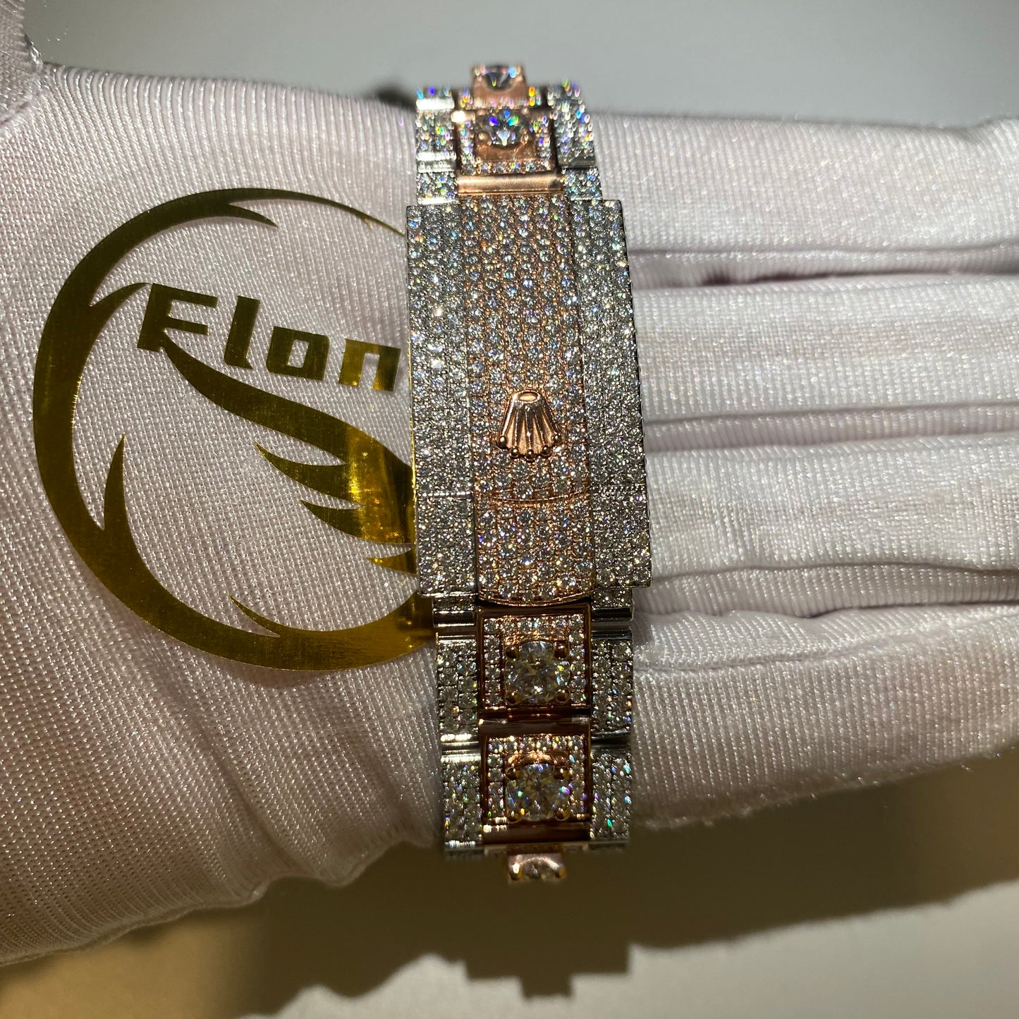 ROLEX DATEJUST ICED OUT WITH ROSE GOLD ROMAN DIAL – LARGE STONES BEZEL TWO-TONE